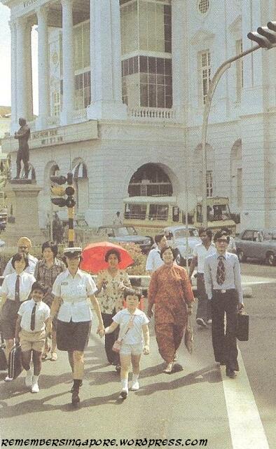 policewoman helping children to cross the road in front of victoria memorial hall 1980